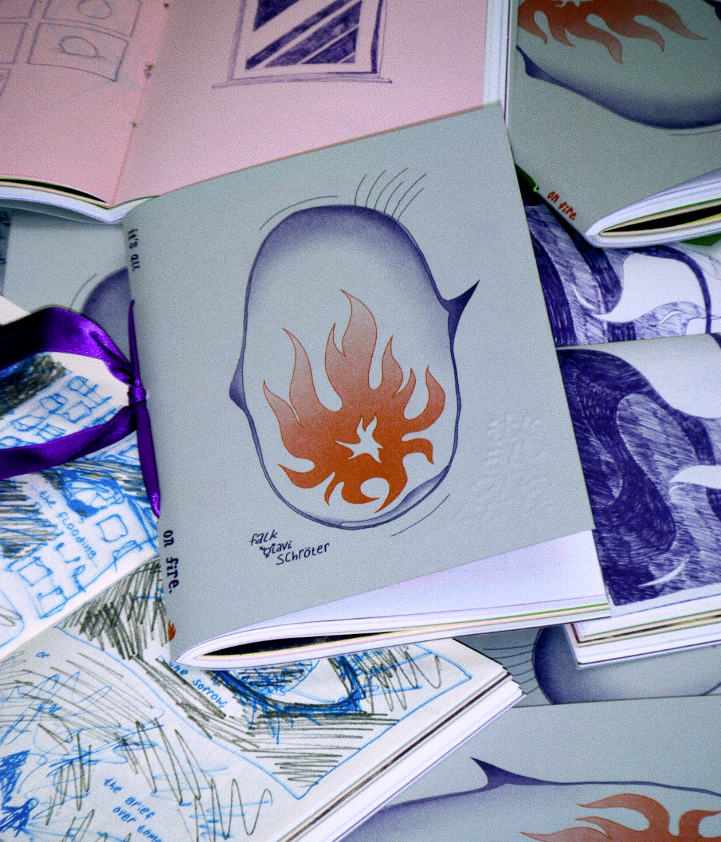 picture of a handbound book, with a large illustrated tear-filled eye, the iris is a flame.